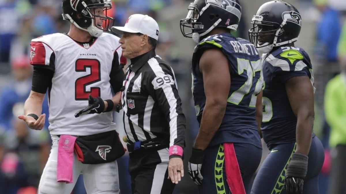Atlanta QB Matt Ryan, far left, is separated by referee Tony Corrente from Seattle Seahawks defensive end Michael Bennett, second from right, and Cliff Avril after an exchange of words on Oct. 16.