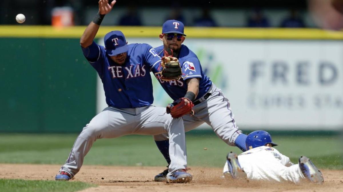 Seattle’s Shawn O'Malley, lower right, steals second as the ball bounces away from Texas shortstop Elvis Andrus, left, and second baseman Rougned Odor on Sunday during the third inning in Seattle.