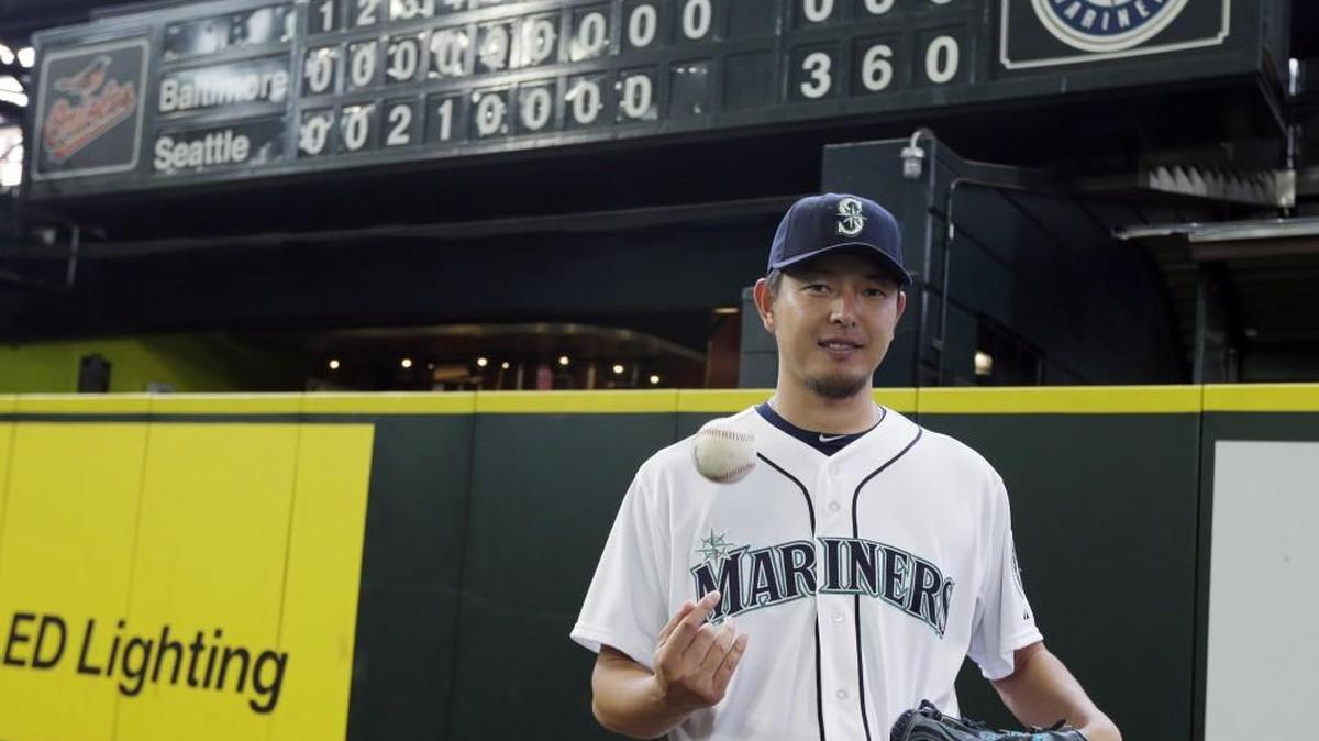 Mariners starter Hisashi Iwakuma poses in front of the manual scoreboard at Safeco Field after he threw a no-hitter against the Orioles on Aug. 12. Iwakuma became a free agent after the close of the World Series.