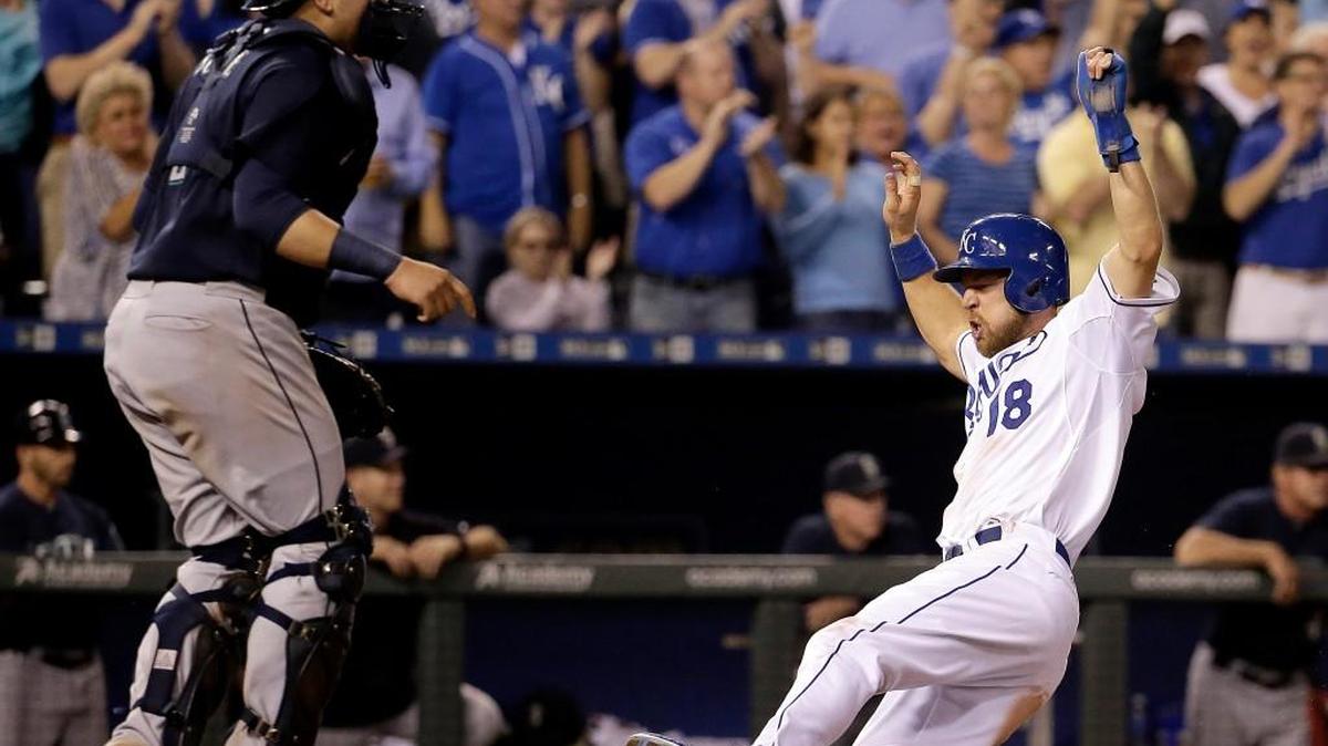 
Kansas City Royals' Ben Zobrist (18) slides home past Seattle Mariners catcher Jesus Sucre to score on a two-run single by Lorenzo Cain during the sixth inning of a baseball game Thursday, Sept. 24, 2015, in Kansas City, Mo.
