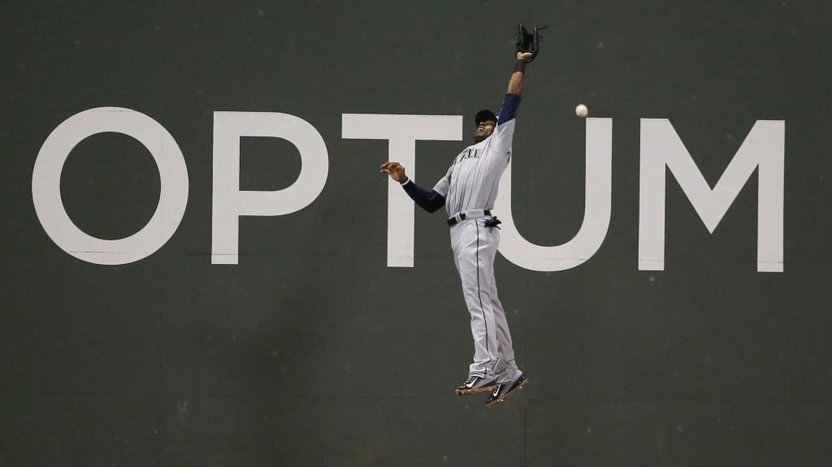 
Center fielder Austin Jackson, failing to catch a ball hit by Brock Holt of the Red Sox in Boston on Aug. 14, was traded by the Seattle Mariners to the Chicago Cubs on Monday. Jackson, a pending free agent, used a recent hot surge to raise his season batting average to .272.
