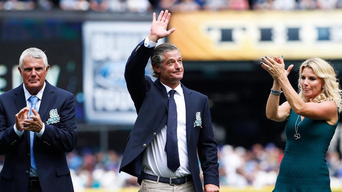 
Former Seattle Mariners pitcher Jamie Moyer, flanked by former Seattle manager Lou Piniella, left, and Moyer’s wife, Karen, waves to the crowd as he is inducted into the Mariners Hall of Fame.
