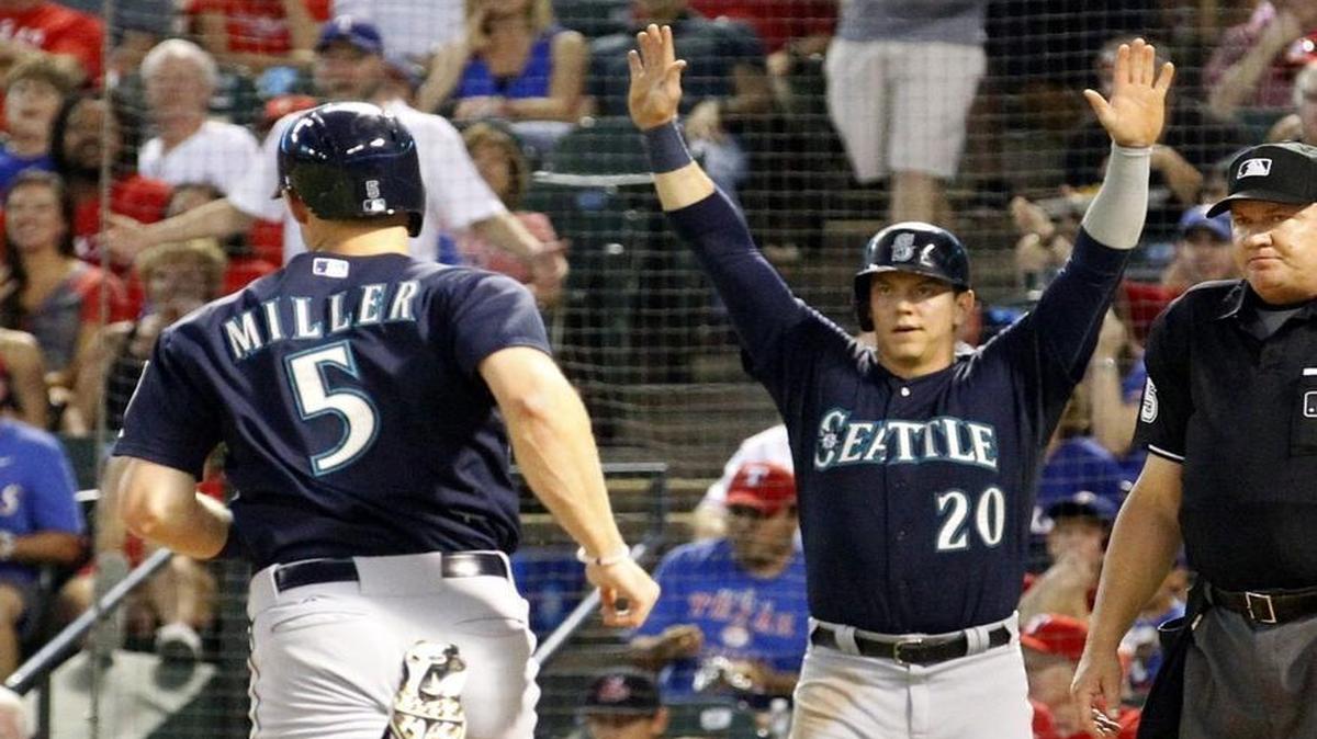 Seattle Mariners shortstop Brad Miller (5) and Logan Morrison (20) score in the second inning against the Texas Rangers in Arlington, Texas, in September. The two were traded Thursday along with Danny Farquhar to Tampa Bay.