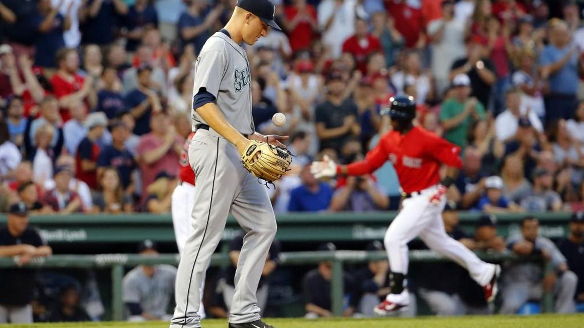 
Mariners left-hander Mike Montgomery tosses a new ball in the air as Boston’s Rusney Castillo rounds the bases after a two-run homer on Aug. 14. Montgomery was optioned to Tacoma on Sunday. 
