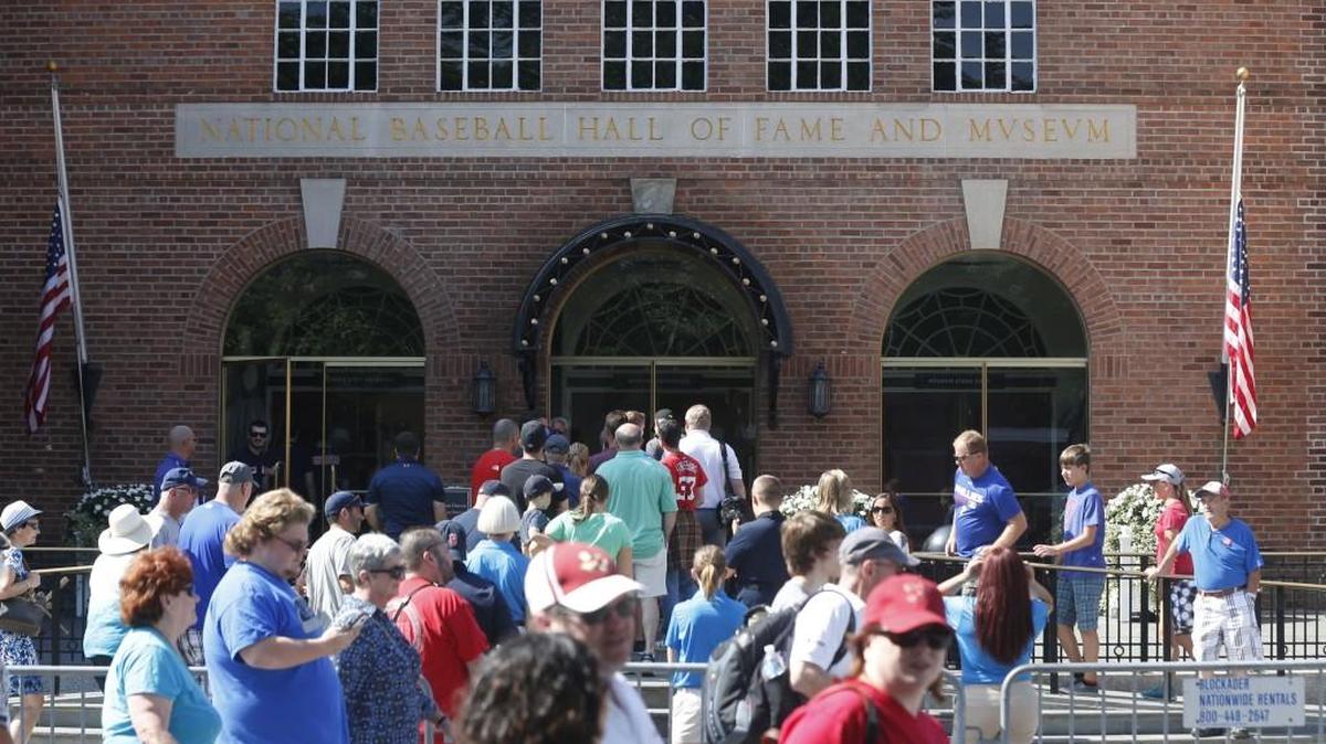Fans walk outside the National Baseball Hall of Fame.