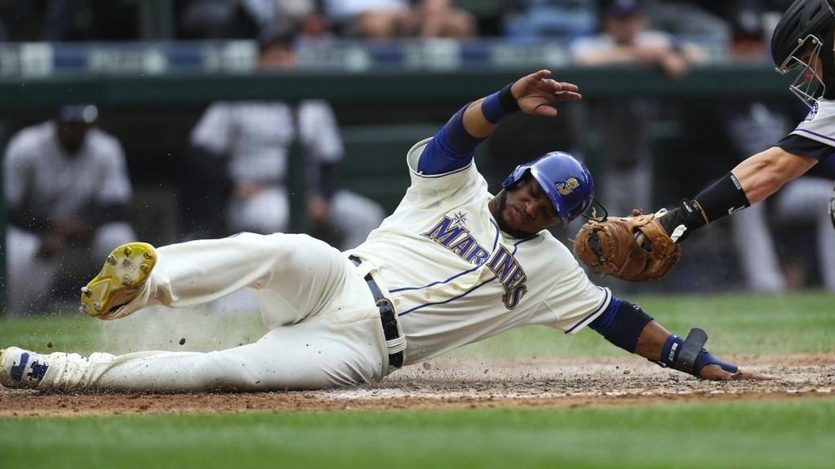 
Seattle Mariners second baseman Robinson Cano slides safely into home in the fourth inning Sunday. Despite lingering soreness, Cano has been one of several hot hitters for the Mariners. Entering Sunday, Cano was batting .323 with 14 doubles and 12 home runs since July. 
