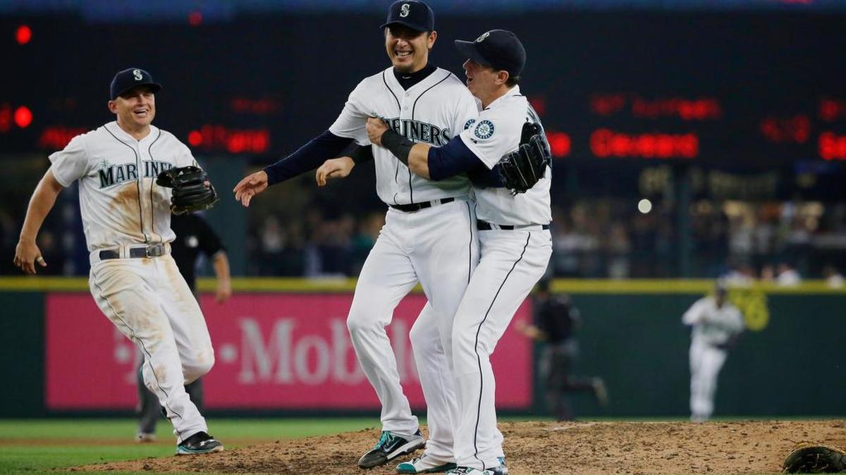 
Seattle Mariners starting pitcher Hisashi Iwakuma second from right, celebrates with third baseman Kyle Seager, left, and first baseman Logan Morrison, right, after Iwakuma threw a no-hitter baseball game against the Baltimore Orioles, Wednesday, Aug. 12, 2015, in Seattle. The Mariners beat the Orioles 3-0.
