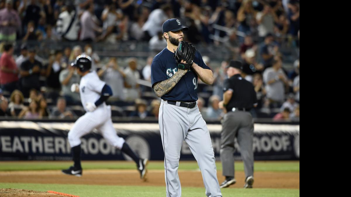 
Mariners relief pitcher Joe Beimel stands near the mound as the Yankees’ Alex Rodriguez rounds third base after hitting what proved to be the game-winning solo home run during the seventh inning of New York’s 4-3 victory at Yankee Stadium on Friday.
