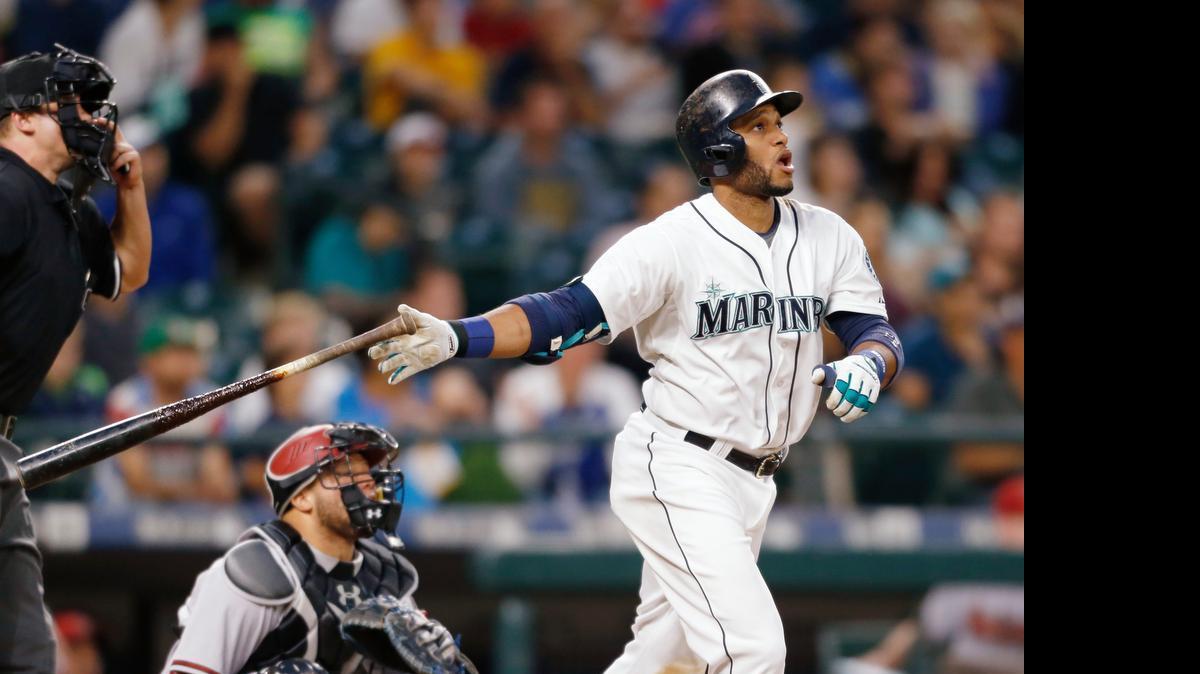 
The Mariners’ Robinson Cano hits a solo home run on a pitch from Robbie Ray of the Diamondbacks on Monday. 
