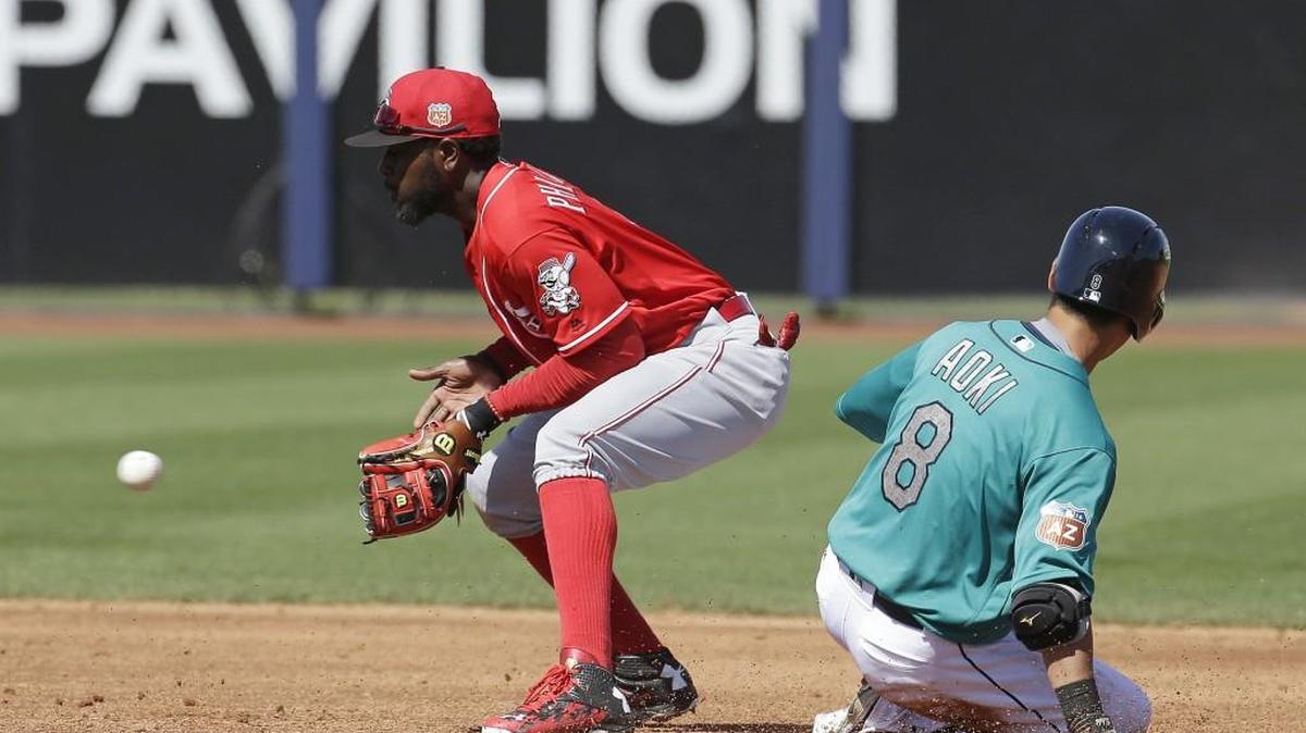 Seattle’s Nori Aoki (8) slides safely into second base as Cincinnati’s Brandon Phillips takes the throw during the third inning Sunday. Aoki had two hits and a walk in his three plate appearances.