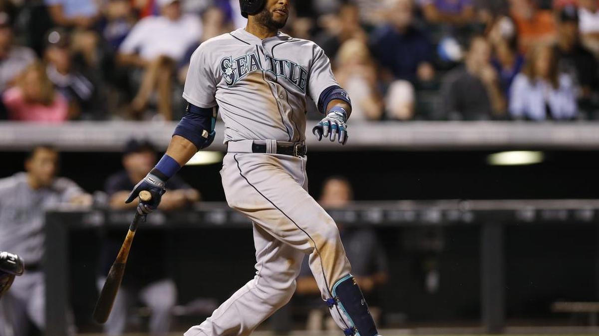 
Robinson Cano of the Mariners follows the flight of his RBI double off Rockies relief pitcher Gonzalez Germen in the seventh inning Monday in Denver. 
