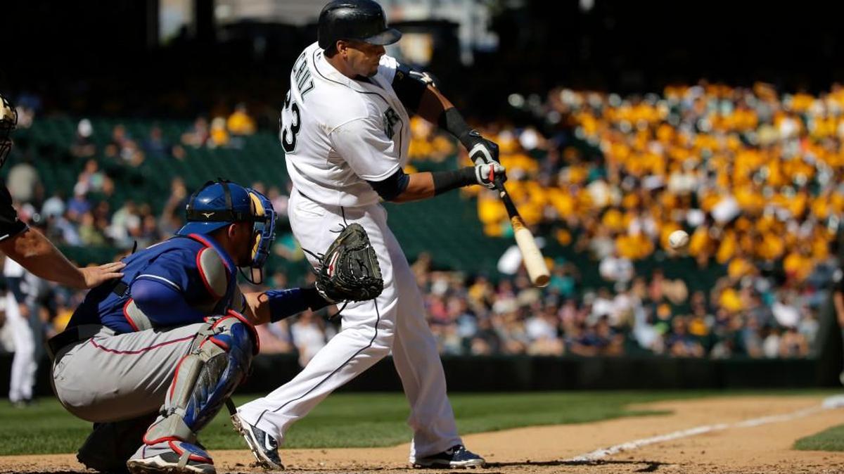 
Seattle’s Nelson Cruz,, in his return after sitting out six games because of a strained right hamstring, hits a two-run home run in the seventh inning against the Texas Rangers at Safeco Field on Thursday.

