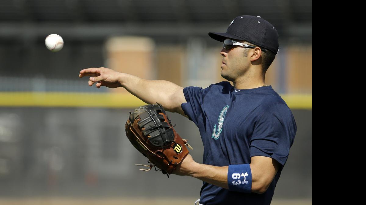 
Seattle Mariners' Jesus Montero throws during spring training baseball practice Saturday, Feb. 21, 2015, in Peoria, Ariz. Montero was called up to the Mariners from Triple-A Tacoma on Thursday, July 9.
