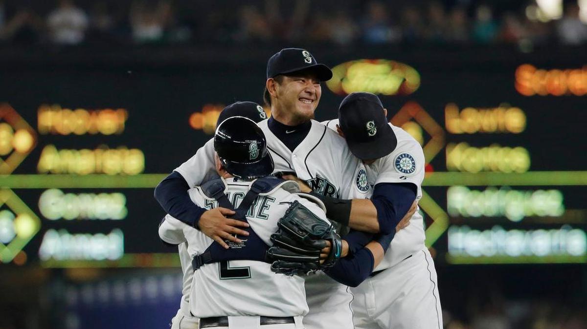 
Seattle Mariners starting pitcher Hisashi Iwakuma, top, is mobbed by teammates including catcher Jesus Sucre (2) after Iwakuma threw a no-hitter in a baseball game against the Baltimore Orioles, Wednesday, Aug. 12, 2015, in Seattle. The Mariners beat the Orioles 3-0.
