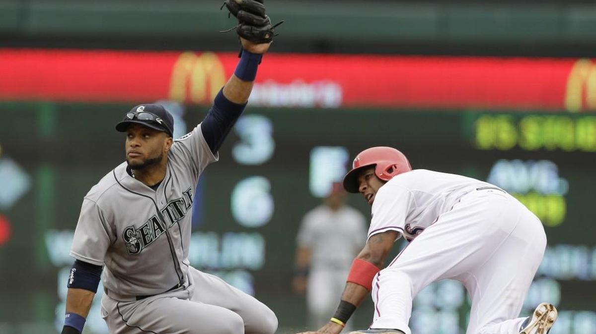 
Seattle Mariners second baseman Robinson Cano, left, holds up the ball after the Texas Rangers’ Elvis Andrus slid into second base for a steal Sept. 20 at Texas. Cano will have surgery Oct. 13 to repair a sports hernia. 
