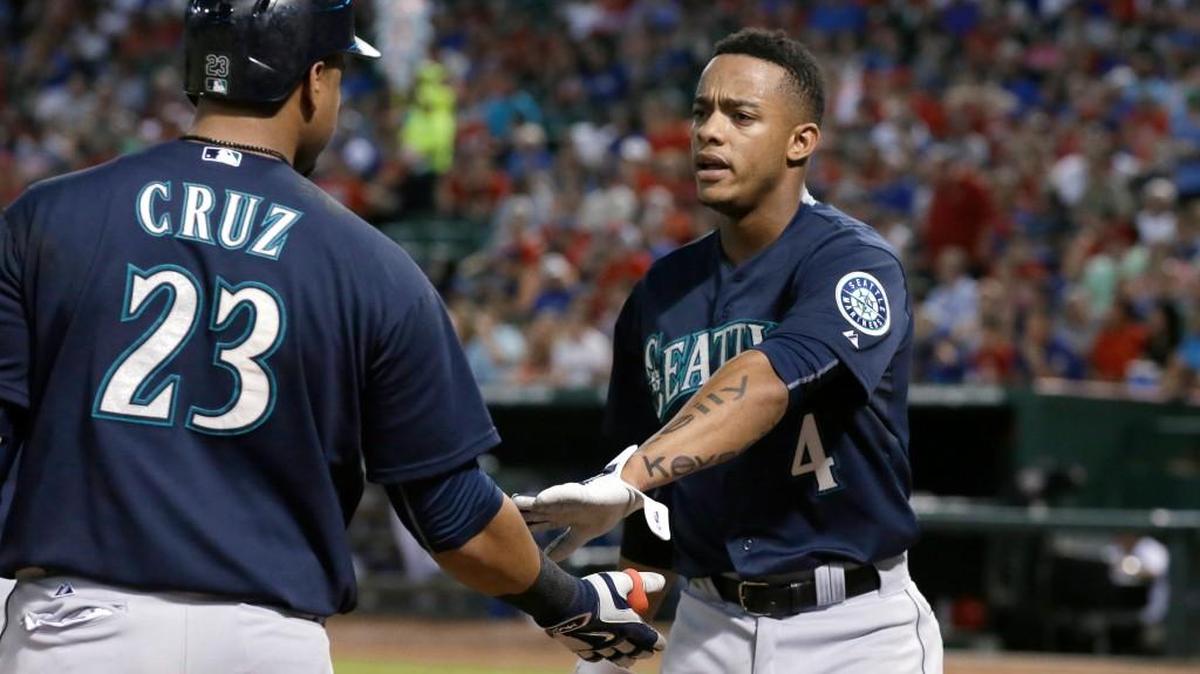 
Seattle Mariners' Ketel Marte (4) is congratulated by Nelson Cruz (23) after Marte scored during the second inning of a baseball game against the Texas Rangers in Arlington, Texas, Friday, Sept. 18, 2015.
