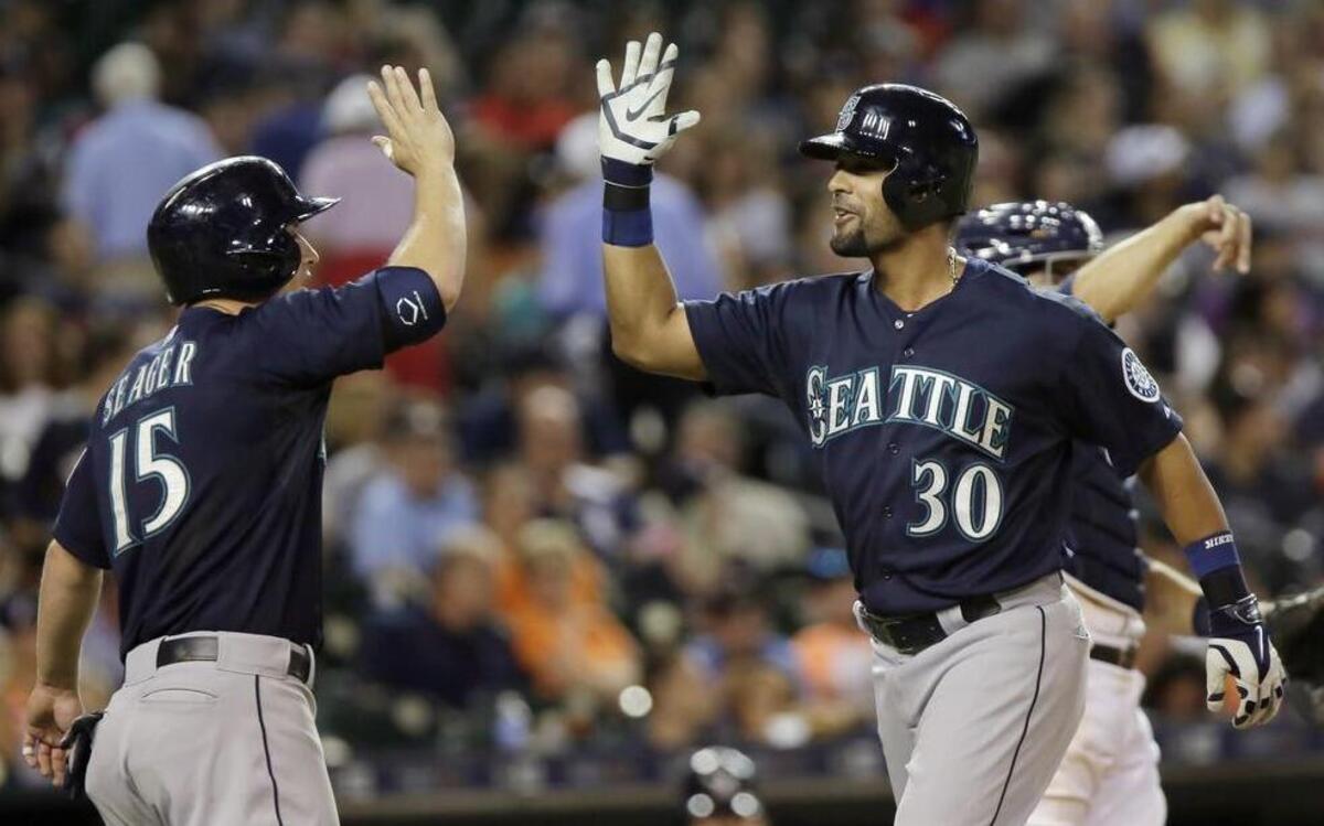 
Seattle Mariners’ Franklin Gutierrez (30) celebrates with Kyle Seager (15) after hitting a grand slam in the eighth inning Tuesday in Detroit.
