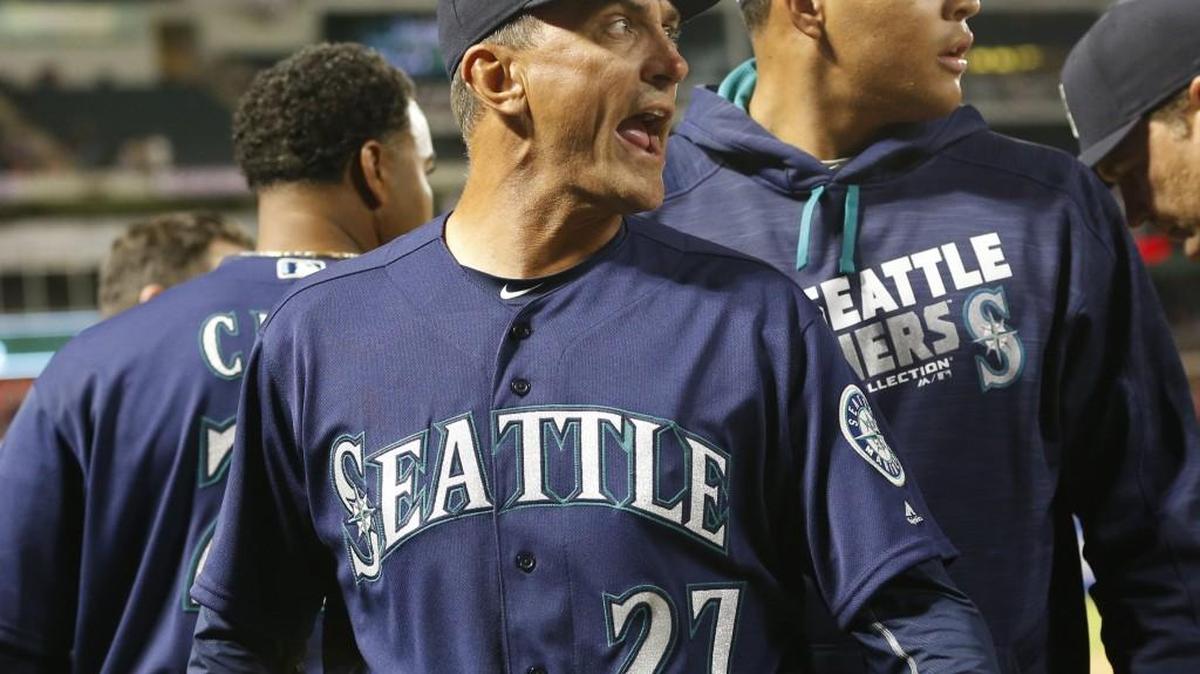 Seattle Mariners bench coach Tim Bogar (27) yells as he heads back to the dugout after Texas Rangers relief pitcher Tom Wilhelmsen hit Chris Iannetta with a pitch during the eighth inning Tuesday.