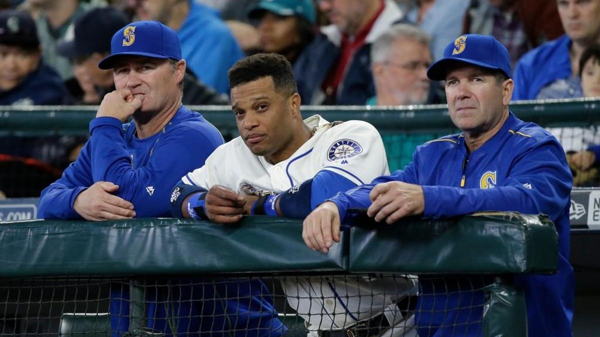 Seattle manager Scott Servais, left; second baseman Robinson Cano, center, and hitting coach Edgar Martinez watch Sunday’s loss to Minnesota. Cano’s solo homer in the first inning was one of the few bright spots for the Mariners.