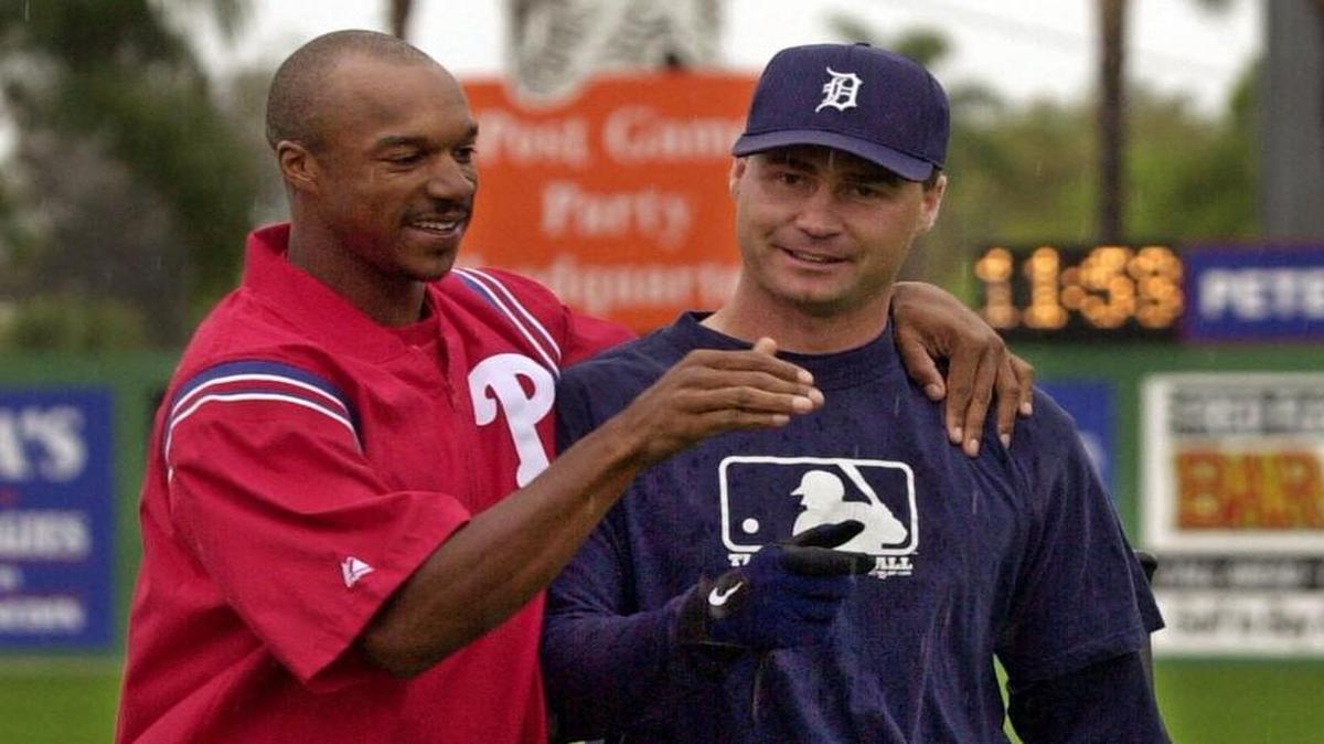 Back in 2001, Philadelphia Phillies outfielder Brian L. Hunter, left, greets Detroit Tigers catcher Scott Servais in spring training. Now, they’re both employed with the Mariners. Servais is the team’s manager and Hunter will coach the Tacoma Rainiers next season.