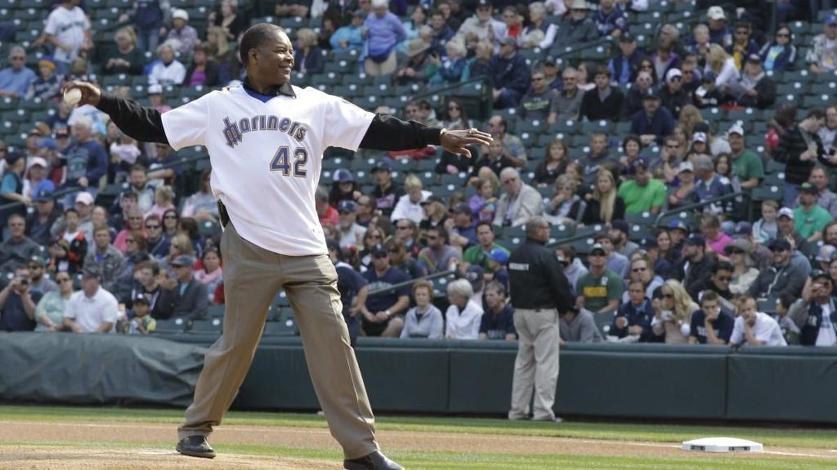 Dave “Hendu” Henderson, who played for the Seattle Mariners from 1981 to 1986, throws out the first pitch of a baseball game against the Texas Rangers, Sunday, Sept. 23, 2012, in Seattle.