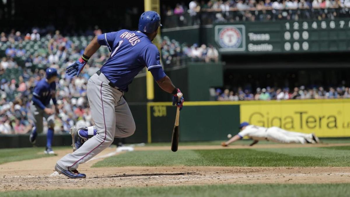 Texas’ Elvis Andrus drives in Ryan Rua with a double as Seattle third baseman Kyle Seager dives in the background during the fourth inning Sunday in Seattle.