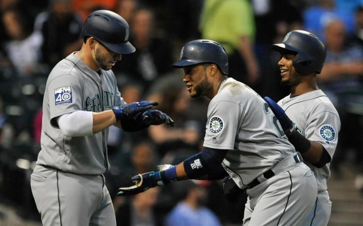Robinson Cano accepts congratulations from Mike Zunino and a pat from Jean Segura after hitting a three-run homer in the third inning.
