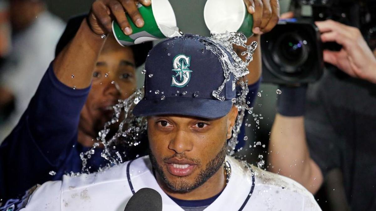 Robinson Cano got playfully doused by teammate Jean Segura while doing a postgame intervew after Tuesday’s 12-3 victory over the Twins.