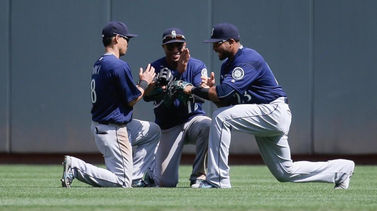 Leonys Martin was in the center of this postgame celebration and in the center of the Mariners’ 5-4 victory over the Reds. Nori Aoki (left) and Nelson Cruz flanked Martin after the final out.