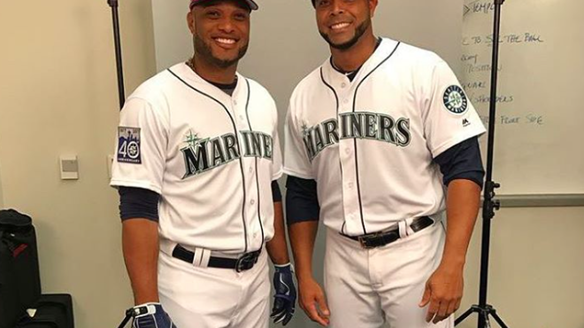 Robinson Cano and Nelson Cruz on Photo Day with Mariners’ uniforms and Dominican Republic caps.