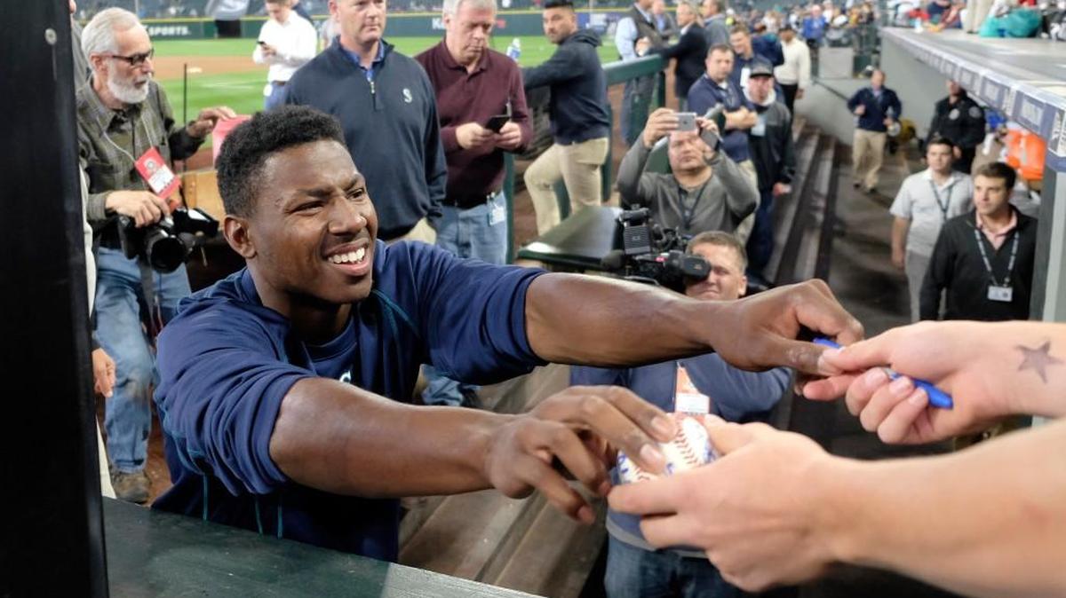 Center fielder Kyle Lewis, the Mariners’ first-round pick, signed autographs Saturday near the dugout after taking batting practice with the big-league club.