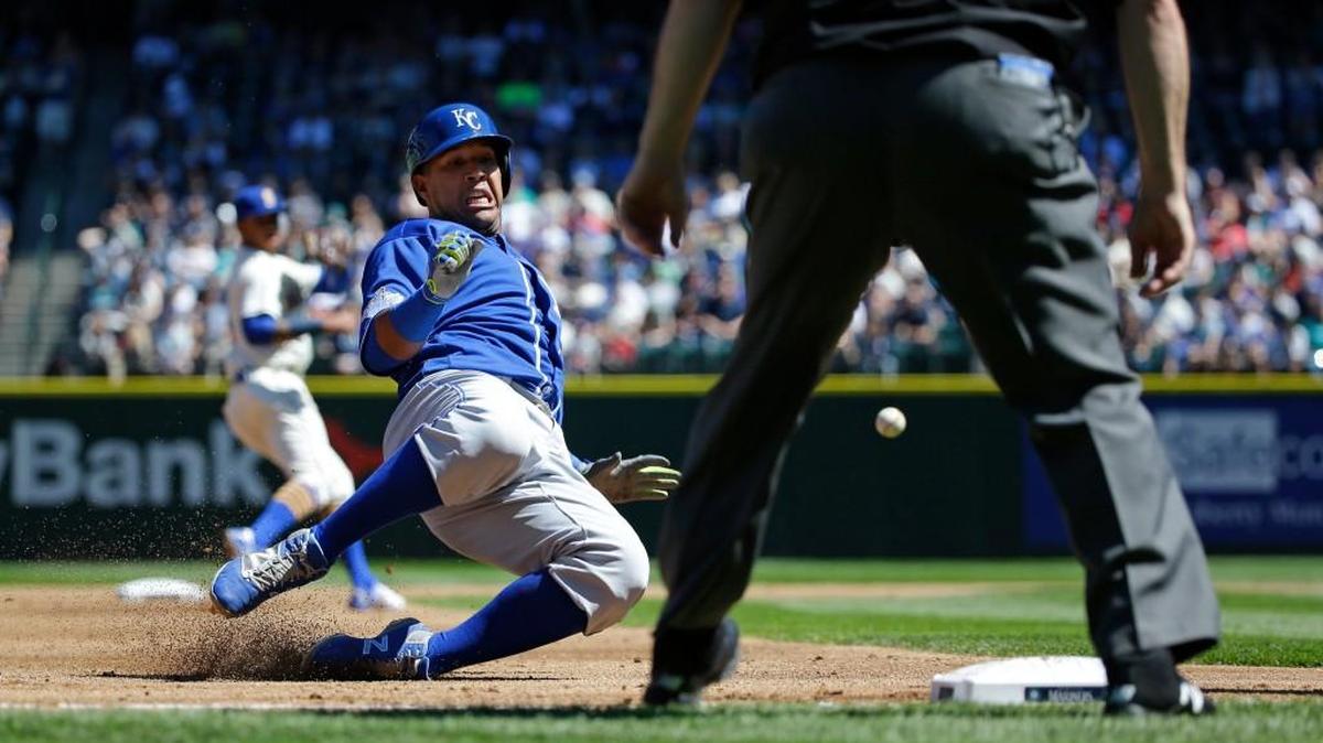 Kansas City Royals baserunner Salvador Perez, left, slides safely into third base as he advances on Omar Infante’s run-scoring single.