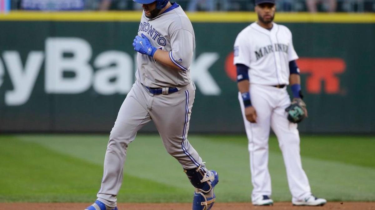 Kendrys Morales rounds second base on his two-run homer in the fourth inning as Robinson Cano looks on.