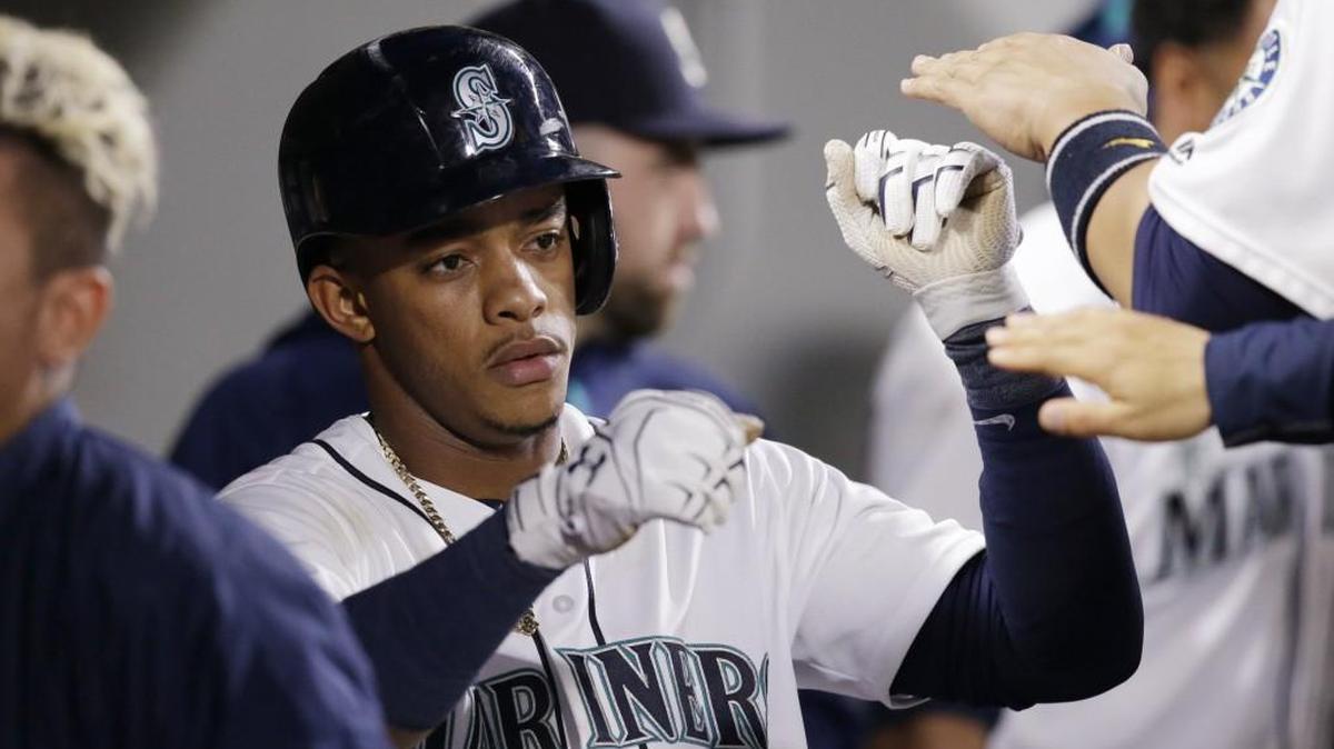 Seattle’s Ketel Marte is congratulated in the dugout after scoring against Tampa Bay on May 9 in Seattle. Marte injured his thumb Saturday against Cincinnati, and how many games he misses is up in the air.