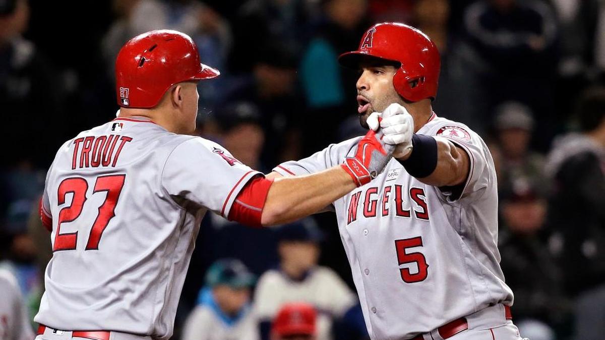 Albert Pujols (right) gets congratulations from Mike Trout after his three-run homer in the ninth inning.