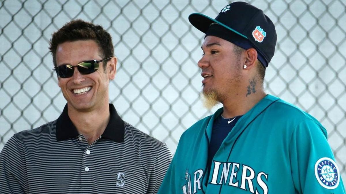General manager Jerry Dipoto (left) shares a moment in spring training with staff Felix Hernandez.