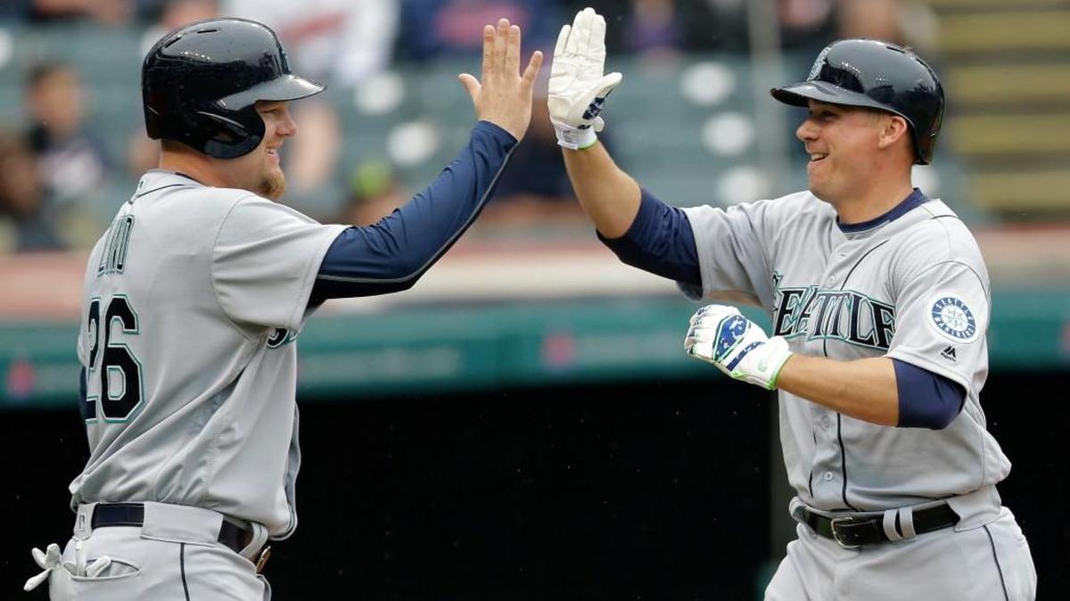 Steve Clevenger (right) gets congratulations from Adam Lind after hitting a two-run homer that gave the Mariners a 2-0 lead.