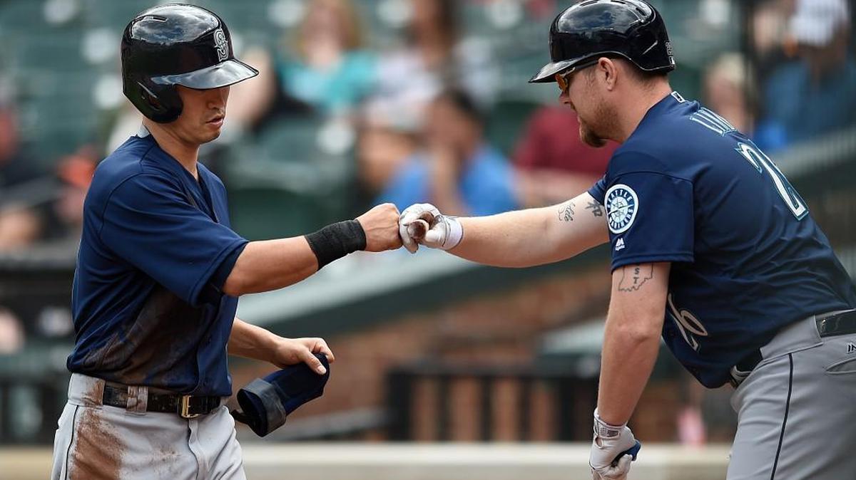 Seattle Mariners' Norichika Aoki, left, is congratulated by Adam Lind after scoring on a single by Nelson Cruz in the first inning of a baseball game against the Baltimore Orioles, Thursday, May 19, 2016, in Baltimore. The Mariners won 7-2.