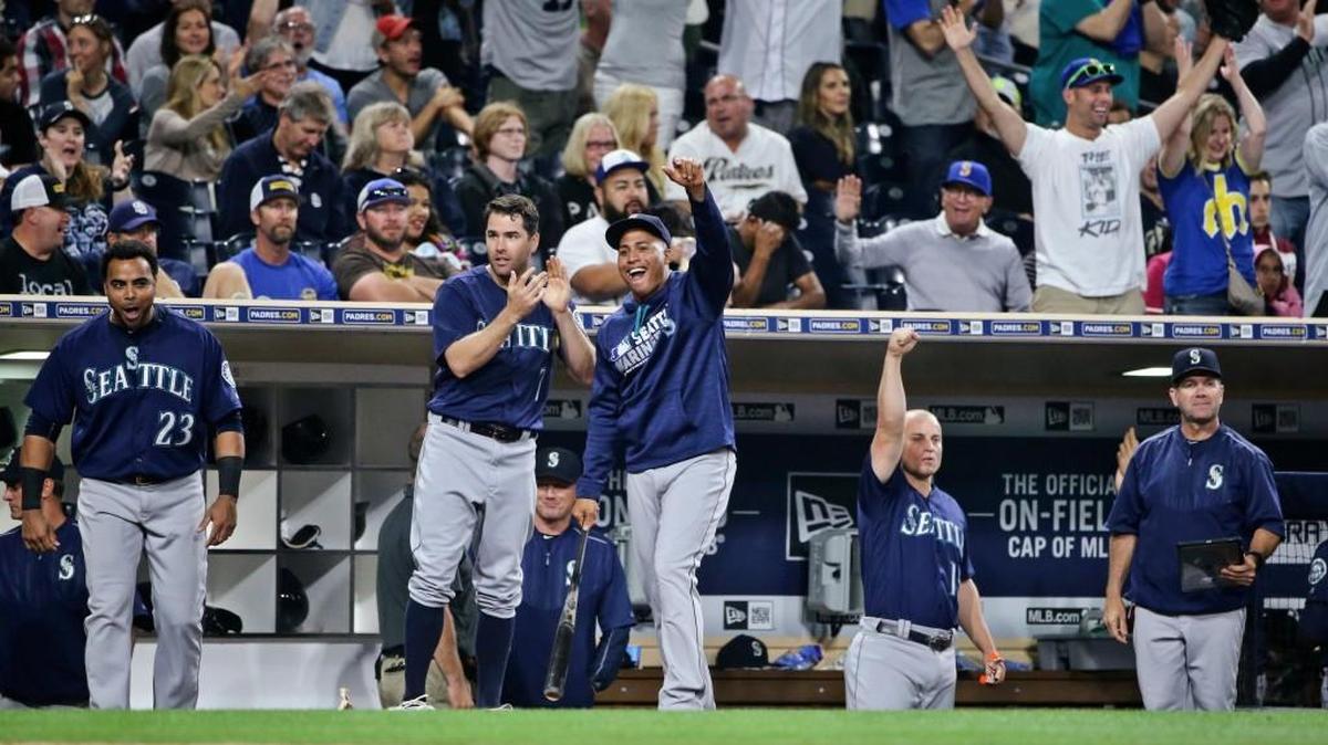 Seattle Mariners, including Nelson Cruz, Seth Smith and Leonys Martin, from left, and fans celebrate as the Mariners score nine runs against the San Diego Padres in the seventh inning of a baseball game Thursday in San Diego.