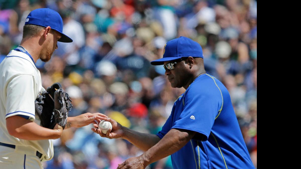 
Seattle Mariners manager Lloyd McClendon, right, removing pitcher David Rollins from the game in the sixth inning against the Los Angeles Angels on Sunday, vows changes will be made for the second half of the season. “We’ve got to get better. ... We have to change things,” McClendon says.
