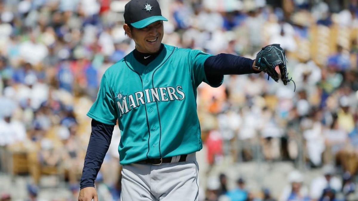 Seattle Mariners starting pitcher Hisashi Iwakuma points to his teammate as he reacts to a double play against the Los Angeles Dodgers on Monday in Glendale. Iwakuma allowed three runs in 4 1/3 innings to get a no-decision.