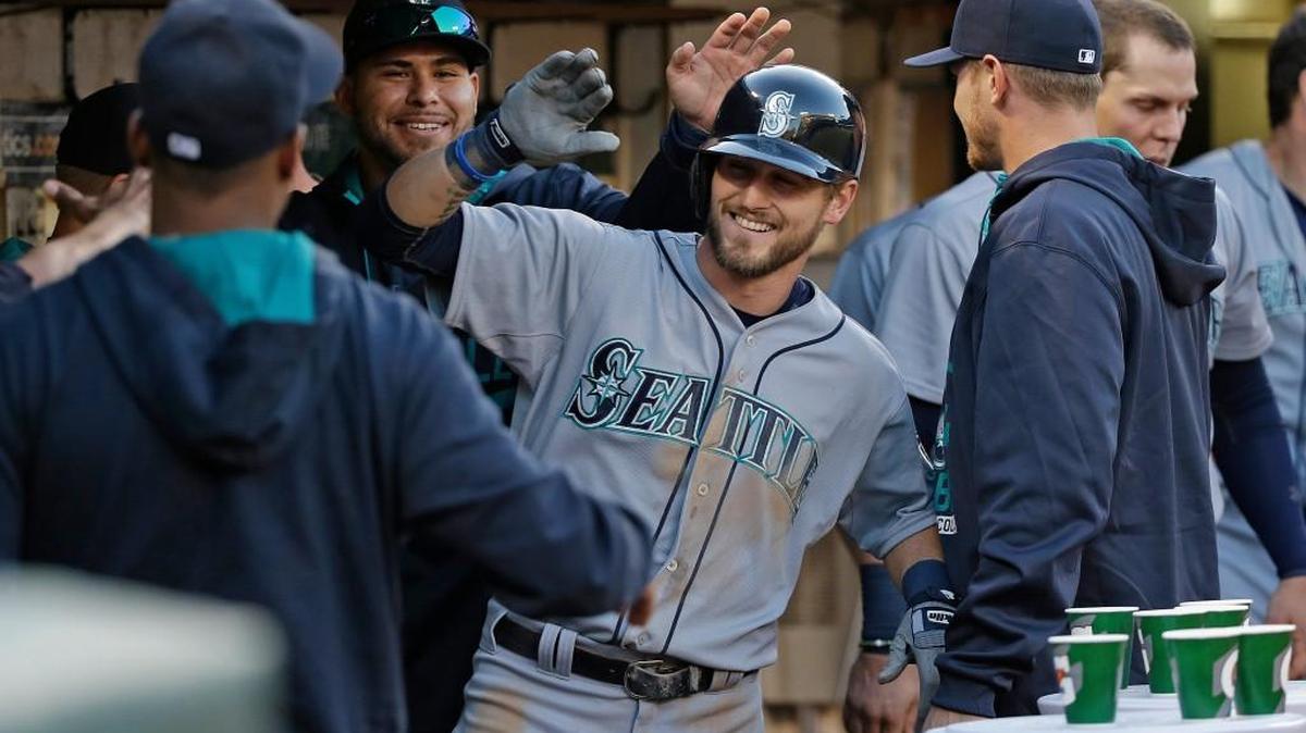 
Mariners rookie Shawn O'Malley is greeted in the dugout after hitting his first major league home run.
