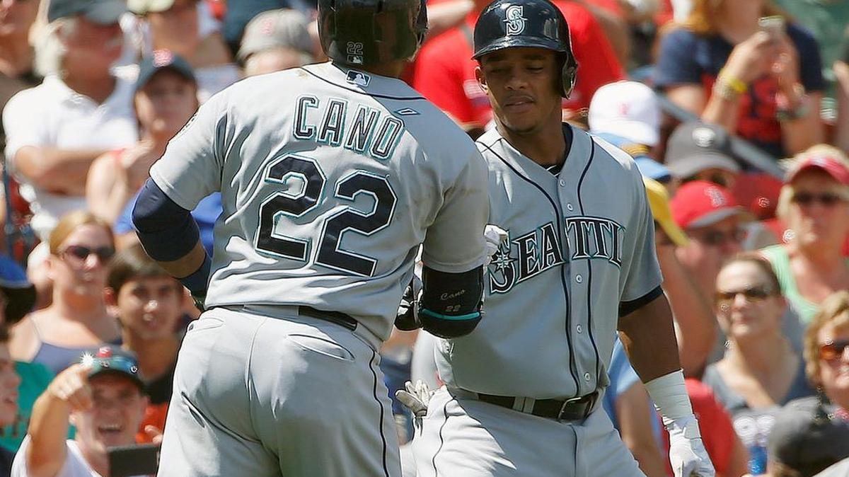 
Seattle Mariners' Robinson Cano (22) celebrates his two-run home run that also drove in Ketel Marte, right, during the first inning of a baseball game against the Boston Red Sox in Boston, Sunday, Aug. 16, 2015. 
