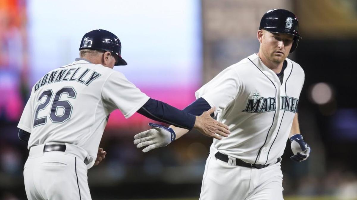 
Mark Trumbo, right, is congratulated by third base coach Rich Donnelly after a two-run home run Wednesday against the Rangers.  Trumbo went 18-for-48 in a 12-game hitting streak that ended Friday.
