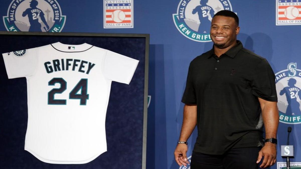 Former Seattle centerfielder Ken Griffey Jr. smiles as he stands near a jersey featuring his No. 24, which the Mariners announced will be retired in a ceremony in August.