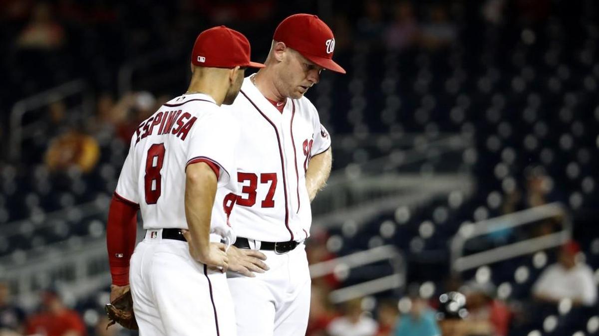 Washington Nationals shortstop Danny Espinosa, left, stands with starting pitcher Stephen Strasburg during the third inning of a game against Atlanta this past Wednesday. Strasburg exited early during his first start after bring on the disabled list.