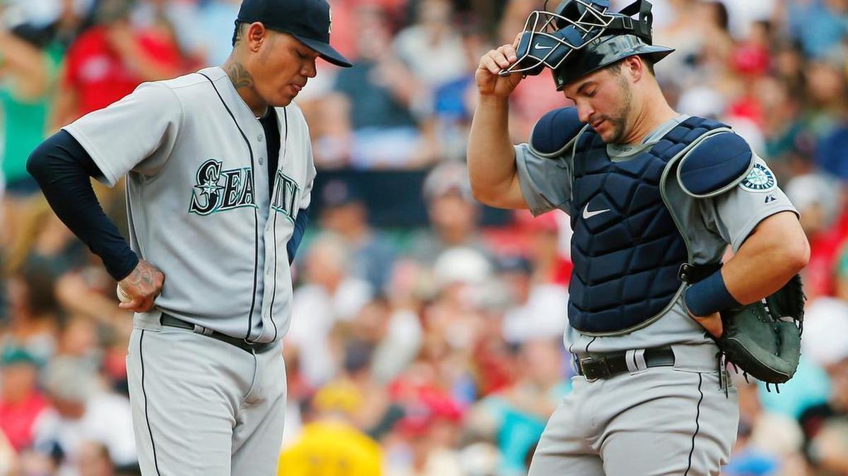 
Seattle Mariners starting pitcher Felix Hernandez, left, and catcher Mike Zunino stand on the mound after giving up a run to the Boston Red Sox during the third inning of a baseball game at Fenway Park in Boston Saturday, Aug. 15, 2015.
