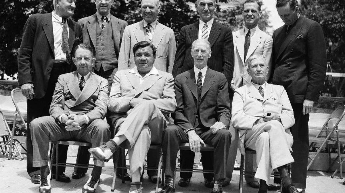 These old-time ball stars were pictured as they attended the dedication of the National Baseball Hall of Fame on Main Street in Cooperstown, New York, on June 12, 1939. Front row, left to right: Eddie Collins, Babe Ruth, Connie Mack, Cy Young; Rear row, left to right: Honus Wagner, Grover Cleveland Alexander, Tris Speaker, Nap Lajoie, George Sisler and Walter Johnson.