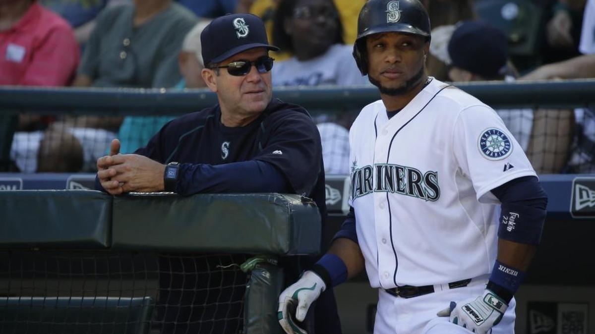 
Seattle Mariners’ Robinson Cano, right, stands with Mariners hitting coach Edgar Martinez during a September baseball game in Seattle. New Mariners general manager Jerry Dipoto says Edgar Martinez showed clearly how invested he was in role as hitting coach and has opted to keep him on staff for another year. 
