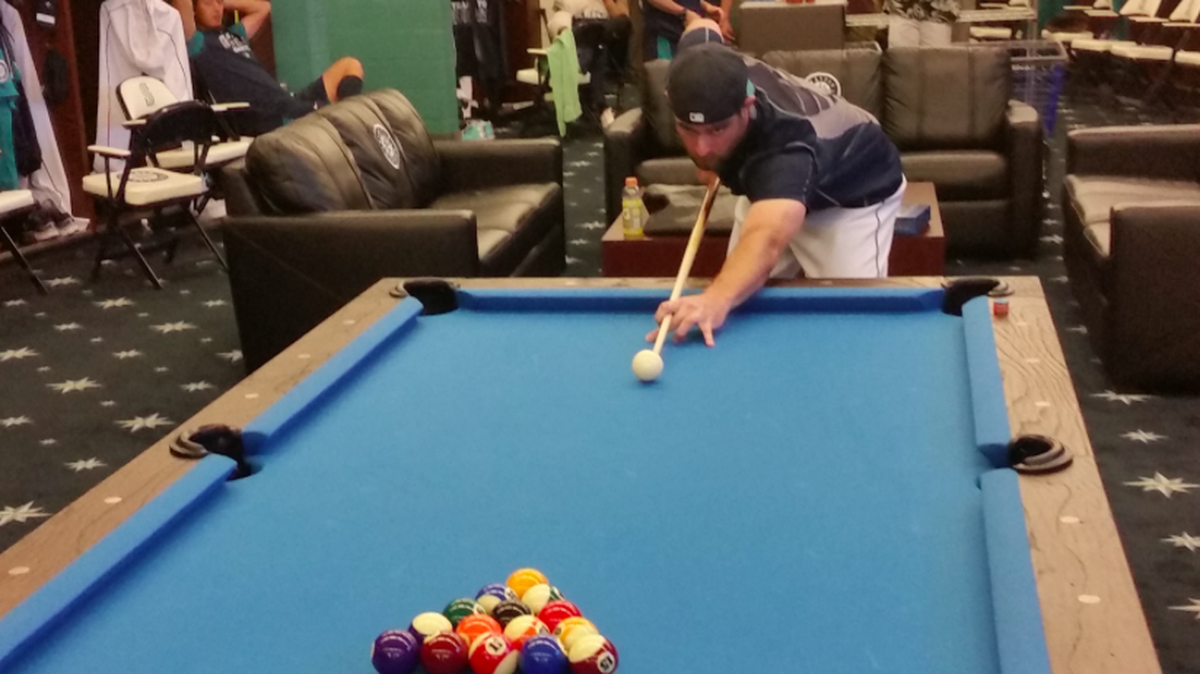 Tony Zych takes aim on the new pool table in the Mariners’ clubhouse.
